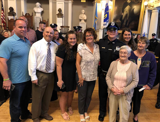 Pete McEvilly (seen left, white shirt and tie) and son, Matthew McEvilly (seen right, police uniform) post-graduation on September 25, 2019.